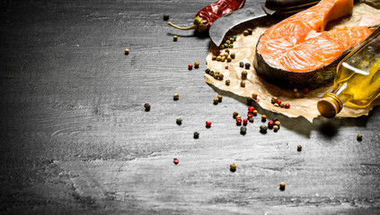 piece of raw salmon with spice and olive oil.