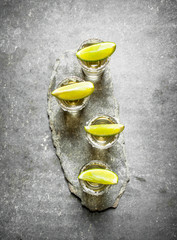 Tequila shots with lime and salt .