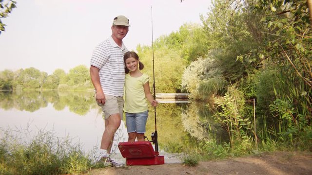 Portrait of father and daughter with a fishing rod