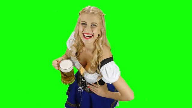 Bavarian girl with a glass of beer in his hand flirts. Green screen