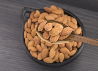 Almonds in wooden spoon