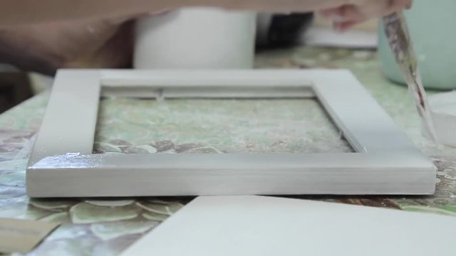 Girl paints a paint box of handmade