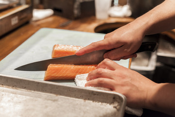 A sushi chef prepares fish for night service. 