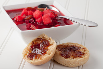 Homemade borscht vegetable beet soup with homemade whole wheat rolls topped with pluot jam