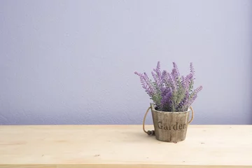 Fototapeten Wood table with purple lavender flower on flower pot and  purple © awaygy