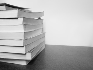 Black & white picture many book on the wooden table, Education concept.