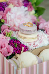 Set of colorful macaroon with wedding or engagement rings on top