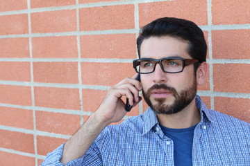 Young businessman talking on his phone outdoors