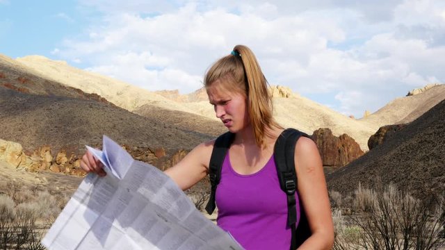 Woman using map to hike