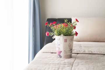 The bed with red common purslane flower on vintage flower pot.