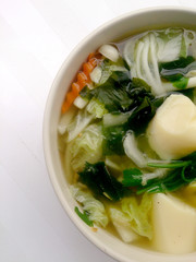 Clear Soup with Bean Curd , mix vegetable, Tofu and seaweed in white bowl on white background. Vegetarian Food, Healthy food, Thai food