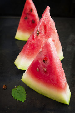 Slices of watermelon on a black background, selective focus
