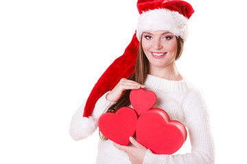 Girl santa helper hat holds heart shaped gift boxes