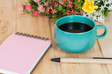 note book  and pen on wood table
