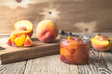 Homemade peach jam on  wooden table