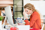 Young woman in office tired