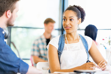 Portrait of smiling afro-american office worker sitting in offfice