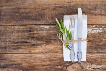 Old cutlery knife and fork on wood background