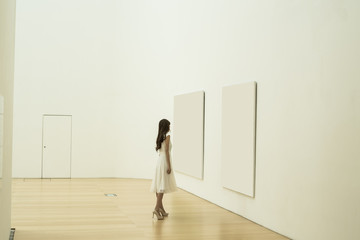 Women are watching a painting at the museum