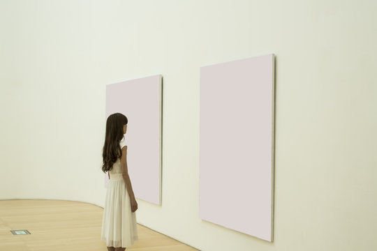 Women are watching a painting at the museum