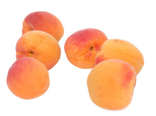 Ripe apricots on a white background