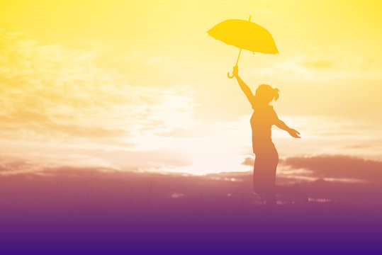 Umbrella woman and sunset silhouette