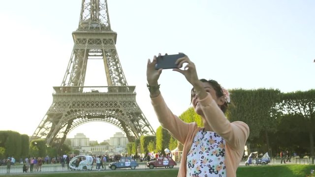 Paris, woman doing a Selfie with Eiffel Tower in background, Slow Motion, HD movie (1920X1080)