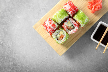 Delicious sushi rolls on table