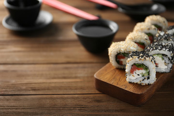 Delicious sushi rolls on table