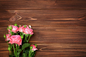 Fototapeta na wymiar Fresh flowers on wooden background