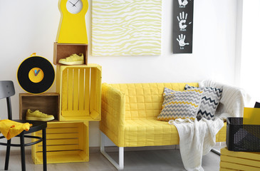 Stylish room interior with yellow couch