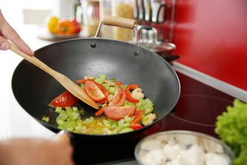 Mixing vegetables in pan closeup