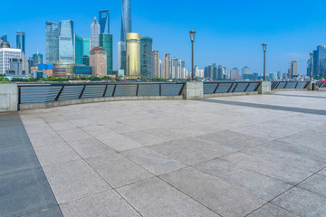 empty brick floor with city skyline background