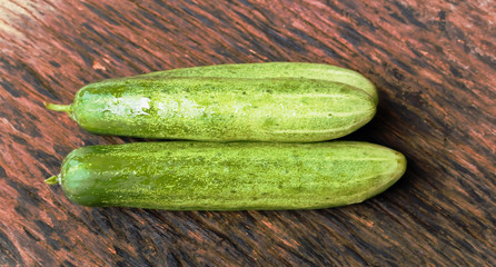 Cucumbers on a wooden background.