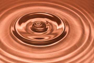 Drop of water, water splash in brown color.