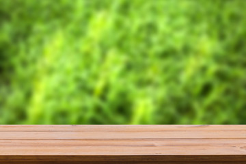 Wooden shelf and grassland on background.