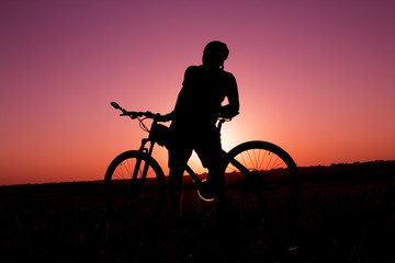 Obraz premium sunset and silhouette backlight bikers