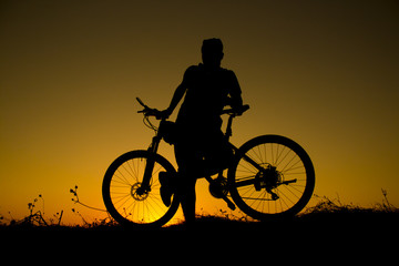 Fototapeta na wymiar sunset and silhouette backlight bikers