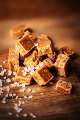 Toffees. Salted caramel pieces and sea salt close up, top view.