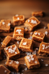 Toffees. Salted caramel pieces and sea salt close up, top view.