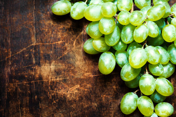 ..Fresh white grapes over wood table macro. Bunch of Grapes on a