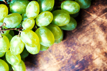 ..Fresh white grapes over wood desk macro. Bunch of Grapes on a