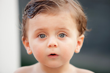 Beautiful baby outside with wet hair