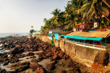 Arambol rock with guesthouses and shacks cafe on the edge of the cliff. North Goa, India