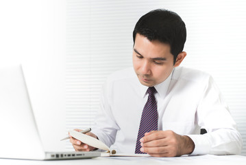 Asian businessman working seriously in the office with laptop computer