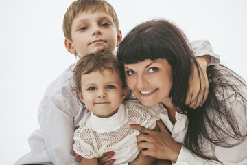 Woman smiling mother that kissing kids