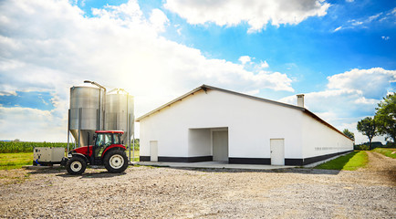 Barn building and modern machinery. - Powered by Adobe