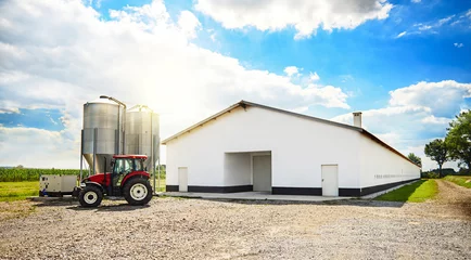 Foto op Canvas Barn building and modern machinery. © gpointstudio