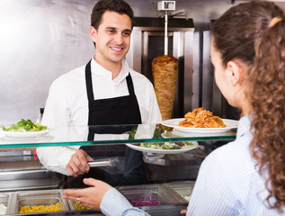 Male worker serving customer