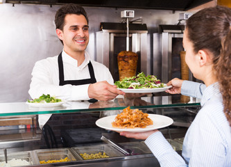 Girl buying kebab and salad